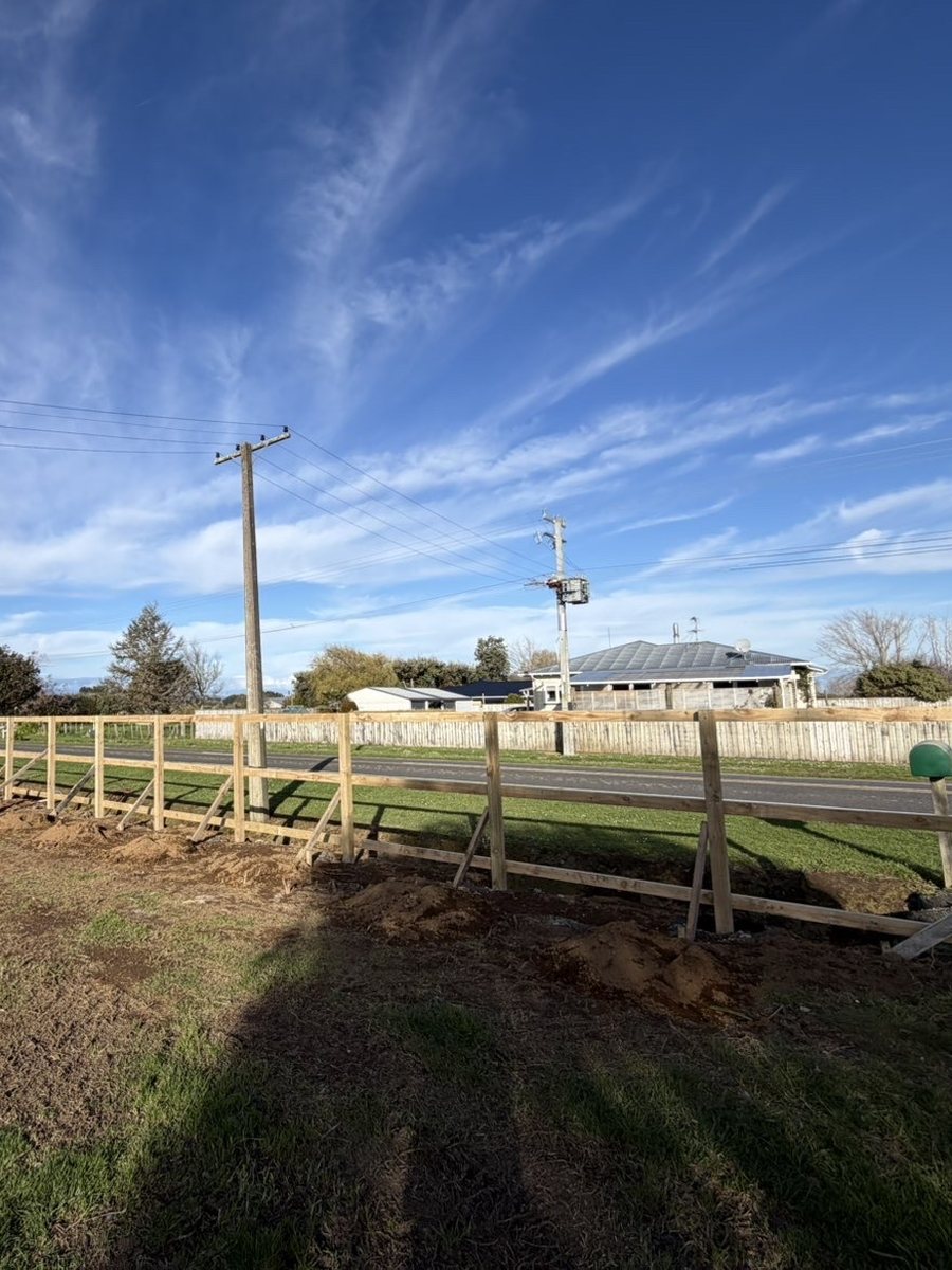 Before: long roadside timber paling fence replacing an open post and rail frame